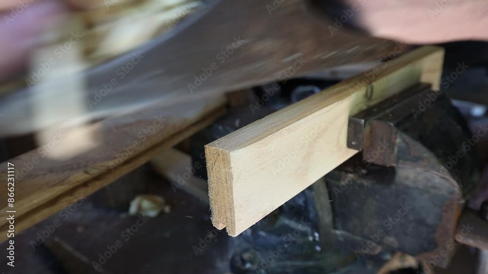 Planing a wooden block in a home workshop, close-up Planing a wooden block in a home workshop, close-up