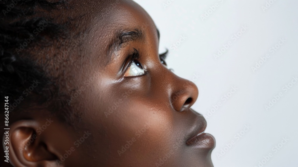 Looking Up. Young African American Woman Half Portrait gazing up with Eyes in White Background Looking Up. Young African American Woman Half Portrait gazing up with Eyes in White Background