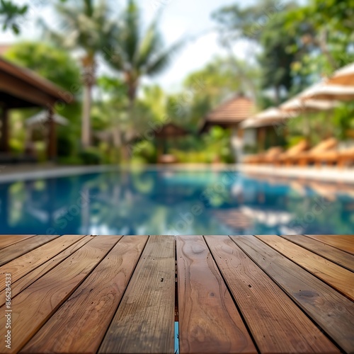 An inviting image of an empty wooden table set in front of a blurred background of a luxurious pool resort, evoking a sense of relaxation and leisure, perfect for promotional materials. 