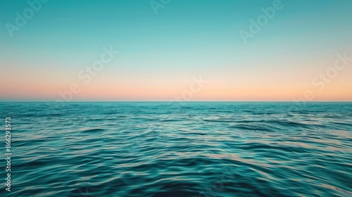 The ocean is calm and peaceful, with a beautiful blue sky in the background