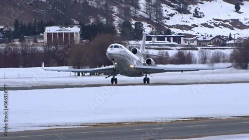 Business jet take off departing at winter landscape snow covered airport airfield remote location mountains valley ski resort exclusive