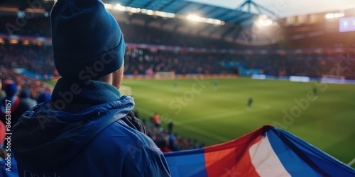 football fan in the stadium. Icelandic soccer supporters watching their team play. a group of supporters applauding with a national shirt and flag. photo