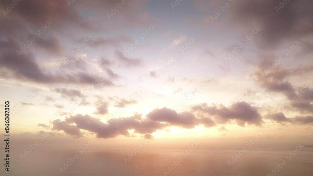 Tranquil sunset scene over the sea, with soft clouds and warm colors enhancing the serene atmosphere. Tranquil sunset scene over the sea, with soft clouds and warm colors enhancing the serene atmosphere.