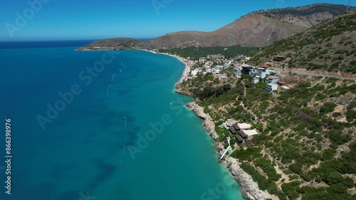 Ionian Sea with Blue Azure Waters and Calm Panoramic Rocky Beach in Albanian Riviera: Premier Tourist Summer Destination photo