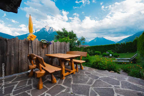 Natural Looking Wooden Bench and Table Outside  in a Garden in the Alps