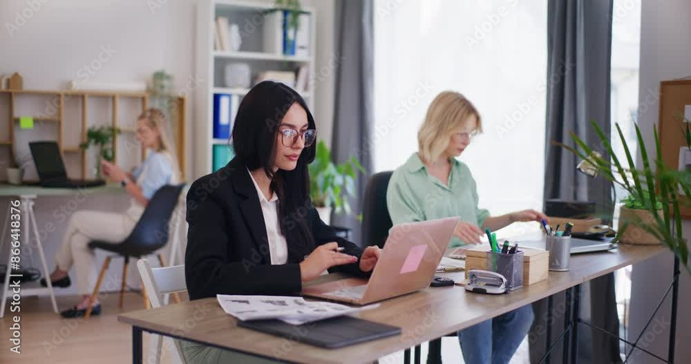 Office Workers Engaged and Focused on Tasks Office Workers Engaged and Focused on Tasks