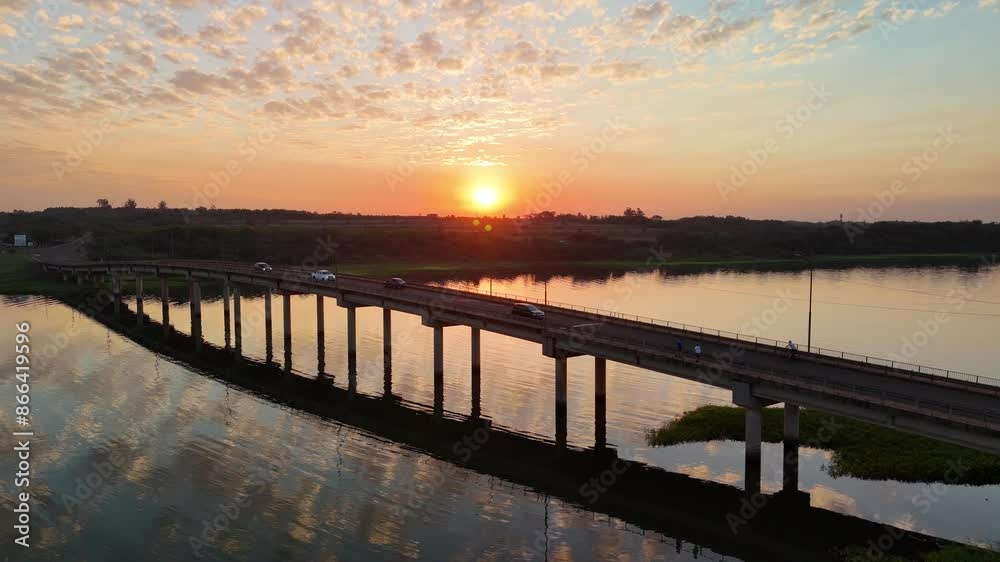 Spectacular aerial view during sunset of the bridge over the Paraná River in the province of Misiones, Argentina. 4k drone. Spectacular aerial view during sunset of the bridge over the Paraná River in the province of Misiones, Argentina. 4k drone.