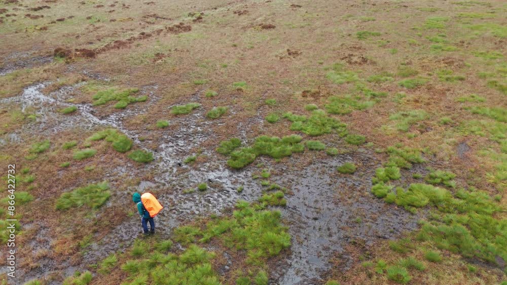Aerial view of a backpacker carefully walking to Axe Edge from Five Stones in England. Aerial view of a backpacker carefully walking to Axe Edge from Five Stones in England.