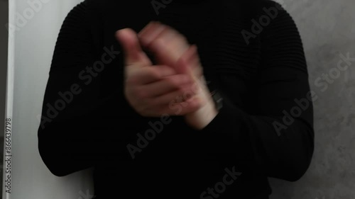 Funny man applauding. Clap hands, man in black clothes claps his hands, Ovation. photo