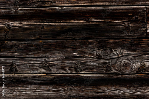 Dark rustic burnt wood background.