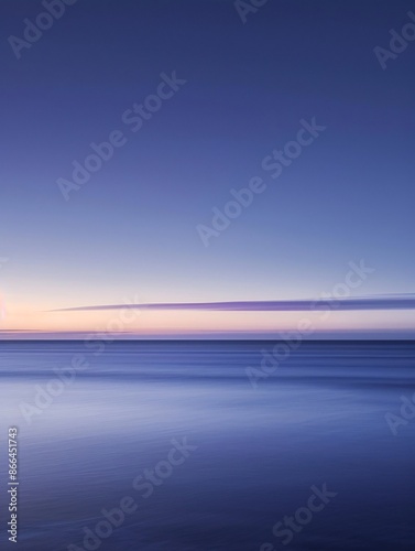 a body of water with a blue sky and clouds photo