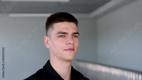 Handsome man with black hair and blue eyes. Mixed race nationality Close up of man face. Serious looking on the camera. Slow motion photo