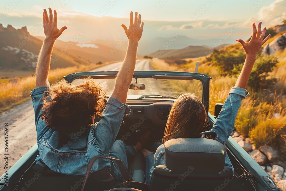 Fototapeta premium Happy couple driving on country road with raised hands