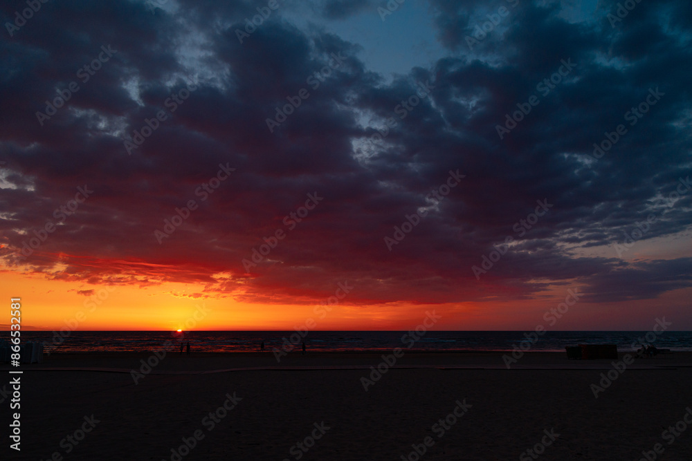 Fototapeta premium A beautiful sunrise over the Baltic sea - horizon and colorful sky. Natural summer scenery at the Baltic beach in Latvia, Northern Europe.
