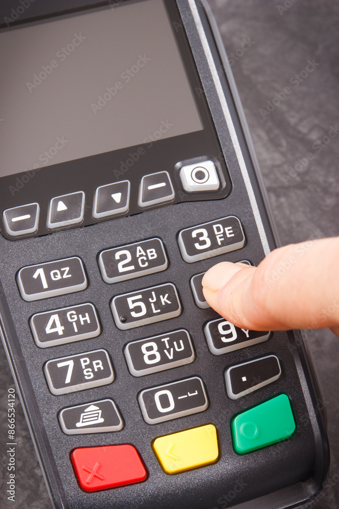 Hand of woman using credit card reader to enter PIN code. Cashless paying. Finance and banking Hand of woman using credit card reader to enter PIN code. Cashless paying. Finance and banking