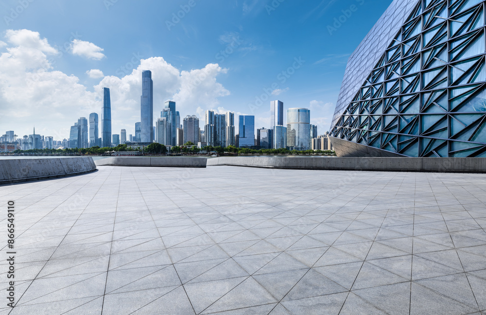 Fototapeta premium Empty square floor with modern city buildings scenery in Guangzhou. car advertising background.