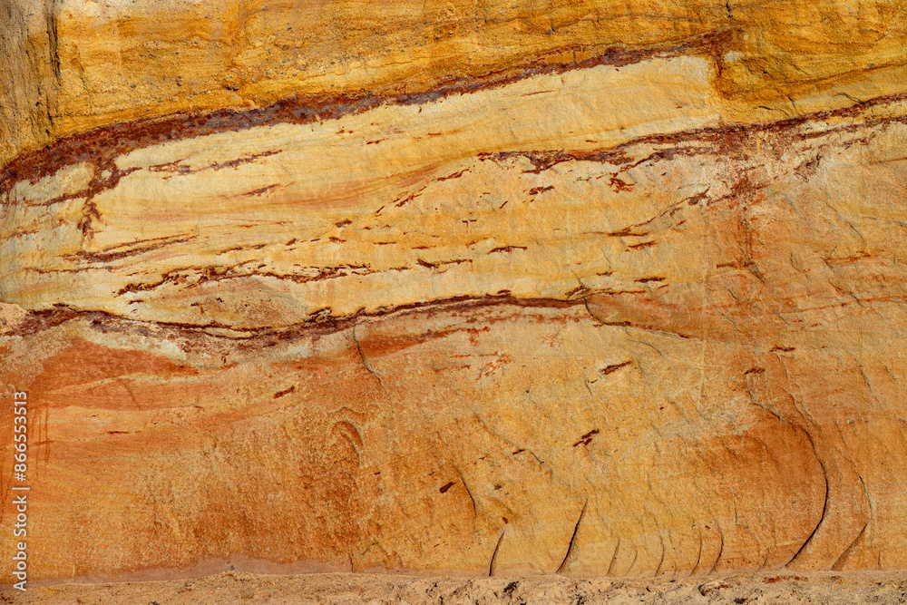 Naklejka premium Natural rock texture background of multicolored sandstone rocks in the Almagreira beach in the Peniche area of the Center region of Portugal.