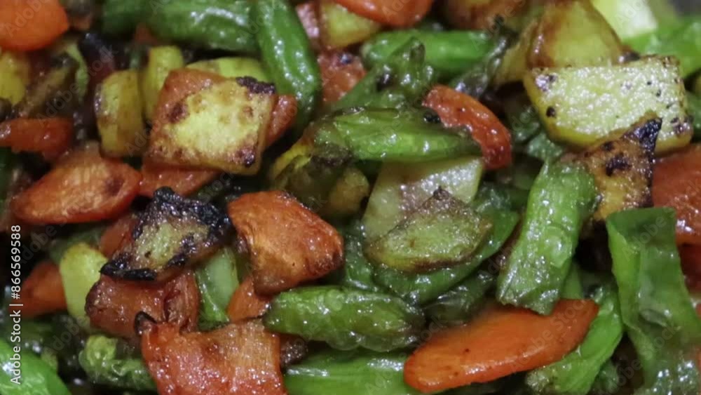 Close-up view of colorful fried vegetables on a pan being mixed and tossed up. Cooking process, healthy food, vegetarian cuisine. Delicious taste, homemade dish. Close-up slow motion.
Close-up view of colorful fried vegetables on a pan being mixed and tossed up. Cooking process, healthy food, vegetarian cuisine. Delicious taste, homemade dish. Close-up slow motion.