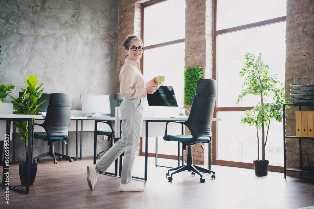 Photo of attractive good mood age lady recruiter dressed formal shirt typing modern device enjoy beverage indoors workplace workstation loft Photo of attractive good mood age lady recruiter dressed formal shirt typing modern device enjoy beverage indoors workplace workstation loft