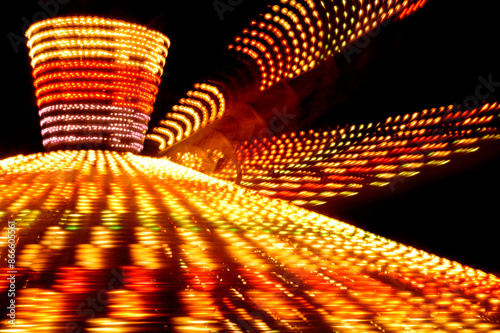 Carousel blurred lights at night in amusement park photo