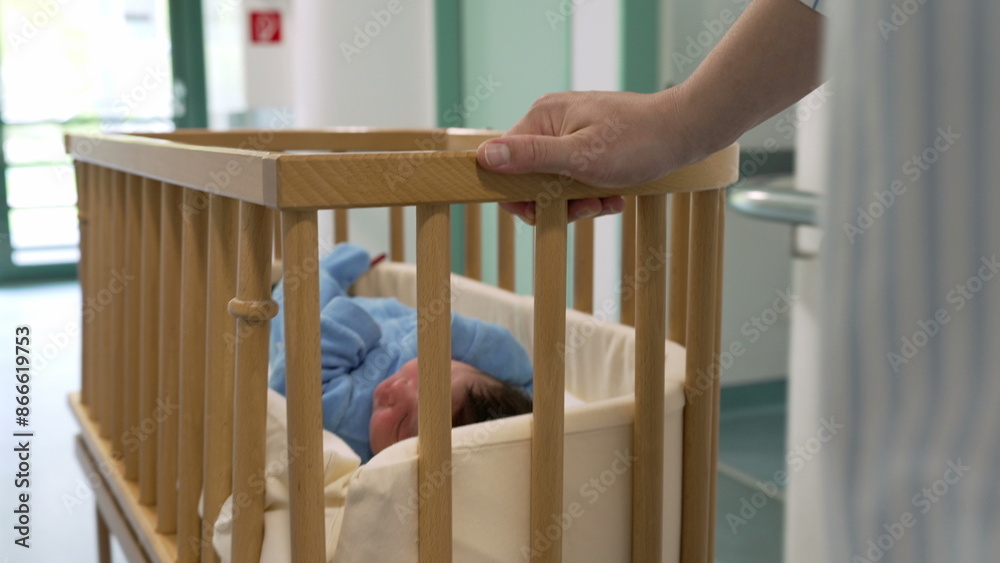 Newborn baby in a wooden crib being transported through hospital corridor, highlighting initial moments of life and tender medical care in a healthcare environment Newborn baby in a wooden crib being transported through hospital corridor, highlighting initial moments of life and tender medical care in a healthcare environment