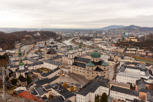 Panoramic view of the old town from the Hohensalzburg fortress. Cloudy and gloomy winter day, St. Peter's Abbey and Baroque Salzburg Cathedral