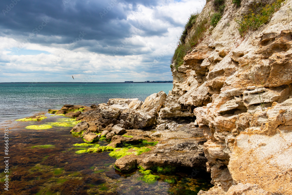 Fototapeta premium Scenic rocks under cloudy May sky near the Fishing port of Ravda, Nesebar municipality, Burgas Province, Bulgarian Black Sea coast