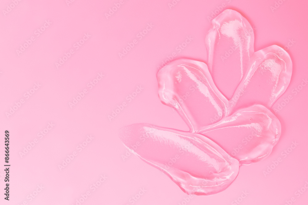 Gel smears cosmetic texture on pink background with space for text Gel smears cosmetic texture on pink background with space for text