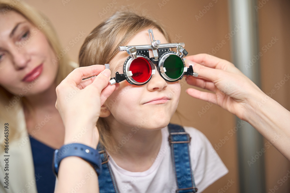 Specialist ophthalmologist uses trial lenses for a little patient Specialist ophthalmologist uses trial lenses for a little patient