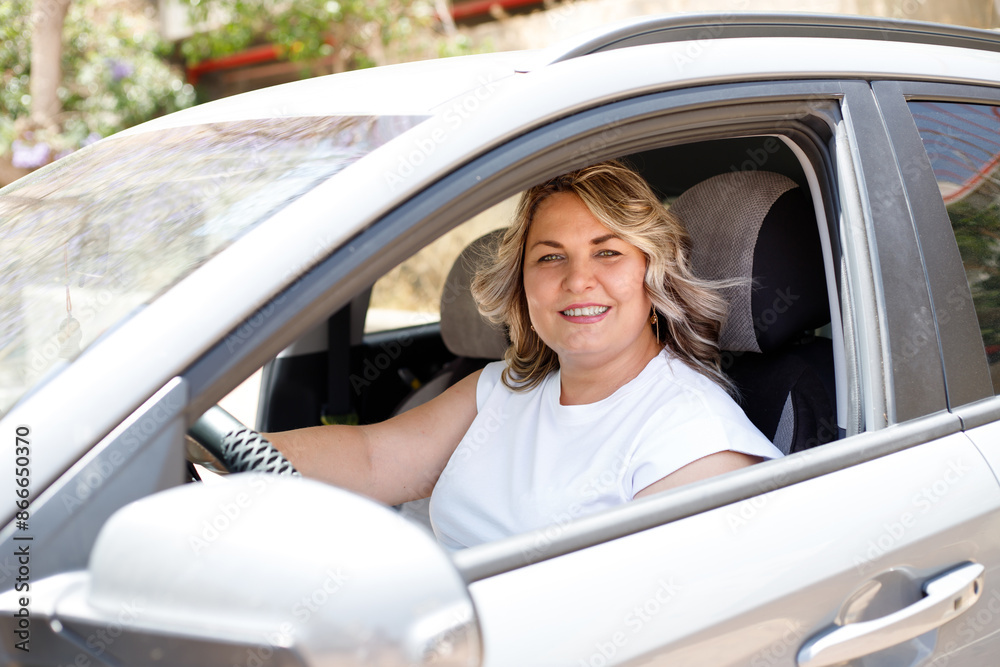 Overweight driver woman client-buyer client sits in a car, chooses a car, wants to buy a new car at a car dealership. Overweight driver woman client-buyer client sits in a car, chooses a car, wants to buy a new car at a car dealership.