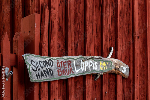 Gavle, Sweden A sign on a red wooden facade says Second Hand, Recycle, Yard sale and Crafts in Swedish translation. photo