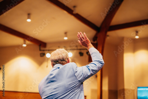 Foto Pastor with hand raised, Preacher Preaching in church,