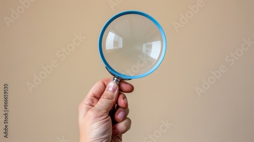 The Hand Holding Magnifying Glass photo