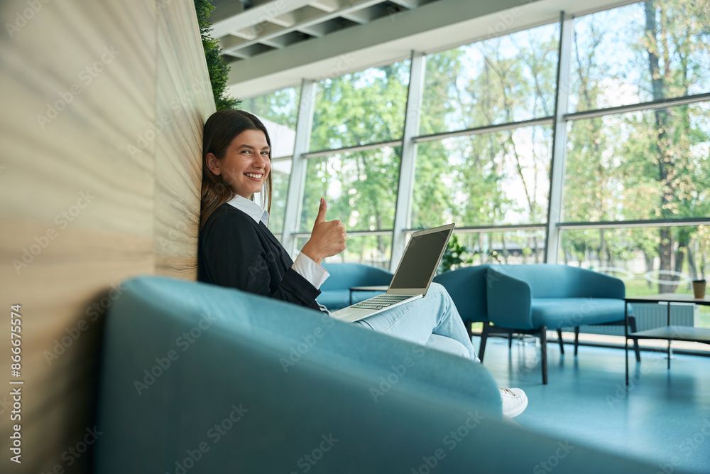 Girl shows thumbs up while looking at camera Girl shows thumbs up while looking at camera