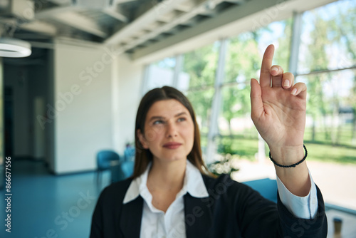 Caucasian girl raised her finger up in the office