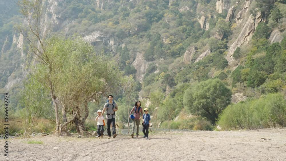 Happy young family hiking outdoors Happy young family hiking outdoors