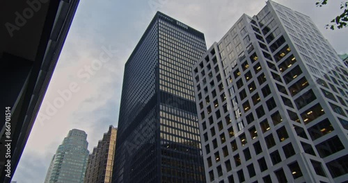 Wallpaper Mural Toronto Skyscrapers Against Evening Sky. Footage of Toronto skyscrapers set against an evening sky, with lights beginning to illuminate, seen from below. Torontodigital.ca