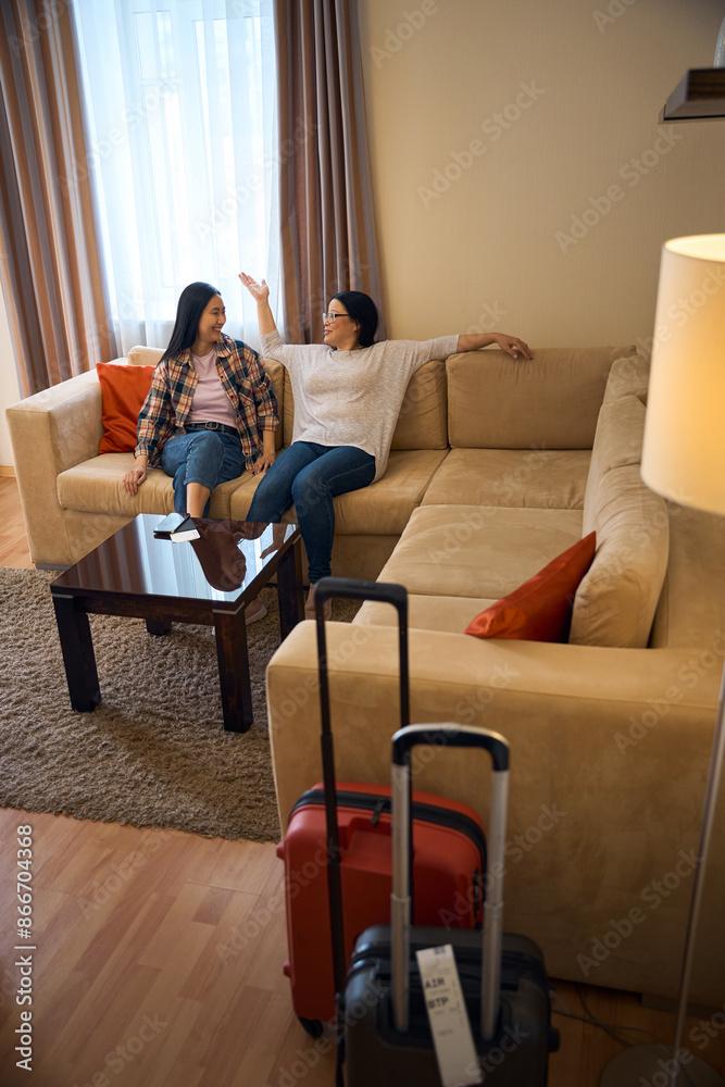 Two female tourists resting in hotel room on arrival Two female tourists resting in hotel room on arrival