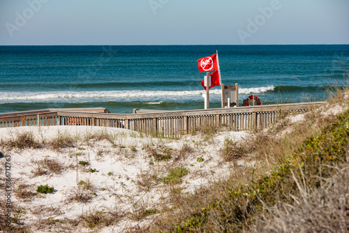 Double red flag warnings fly at north Florida during spring, following major storm, at Topsail Hill Preserve, Santa Rosa Beach, Florida