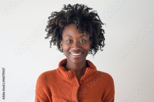 Portrait of a grinning afro-american woman in her 30s wearing a thermal fleece pullover on white background