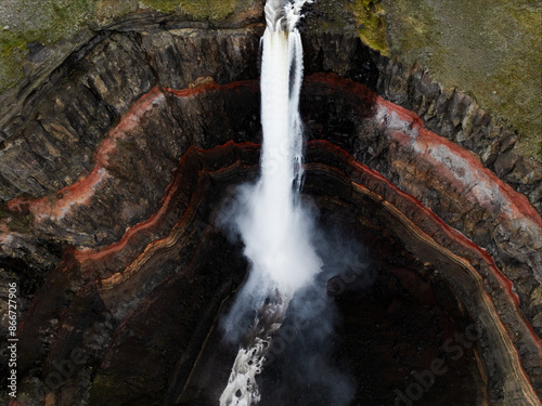 Obraz na płótnie View from above, stunning aerial view of the Hengifoss Waterfall. Hengifoss, is eye-catching due to the striking red clay and black basalt patterns of the cliff face. Fljótsdalshreppur, East Iceland. w salonie