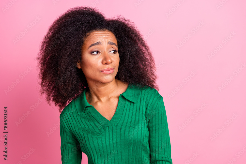 Photo portrait of attractive young woman look skeptical empty space dressed stylish green clothes isolated on pink color background Photo portrait of attractive young woman look skeptical empty space dressed stylish green clothes isolated on pink color background