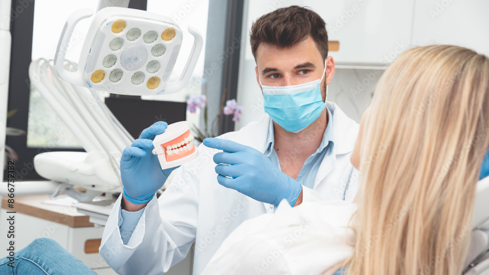 Dentist showing jaw model. Dental treatment Dentist showing jaw model. Dental treatment