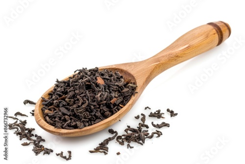 A close-up shot of a wooden spoon filled with black tea leaves, often used for brewing tea