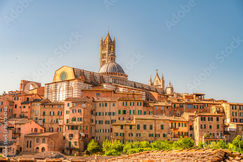 Siena, medieval town in Tuscany, with view of the Dome & Bell Tower of Siena Cathedral,  Mangia Tower and Basilica of San Domenico, Italy © alexanderuhrin