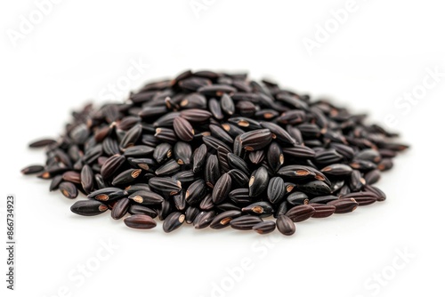 A picture of black rice piled high on a white surface, great for food-related or cultural-themed projects