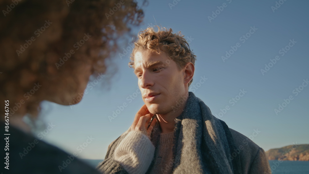 Curly woman touching man face hand at windy seashore closeup. Romantic moment Curly woman touching man face hand at windy seashore closeup. Romantic moment