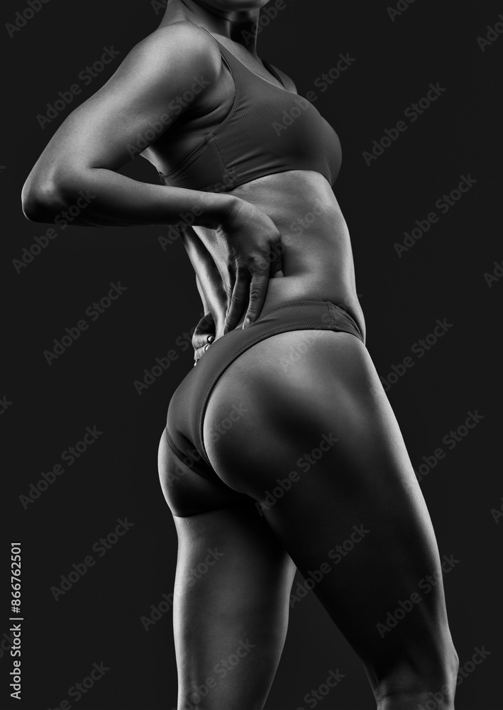 Naklejka premium A young beautiful woman with a slim and muscular figure and dark skin in blue underwear. The concept of weight loss and healthy lifestyle.