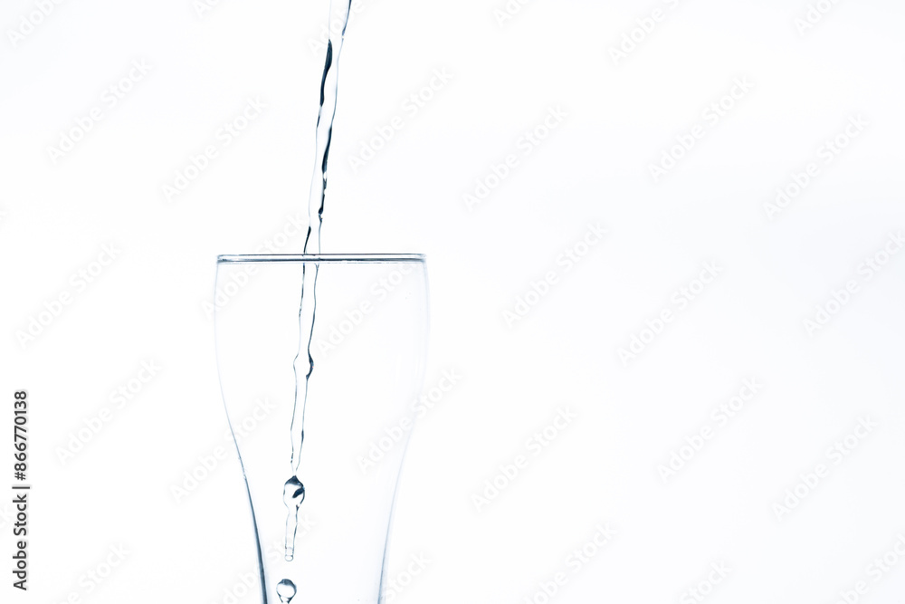 Pouring water into a glass on a white background. Close-up image,Glass of drinking water isolated on white background Pouring water into a glass on a white background. Close-up image,Glass of drinking water isolated on white background