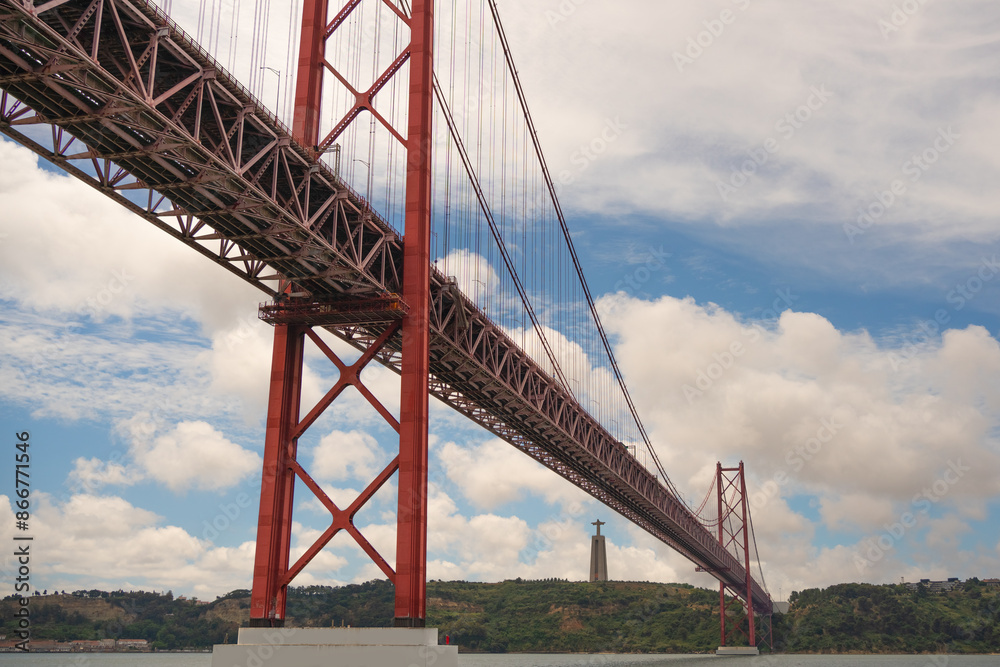 Obraz premium 25 April Bridge over the Tagus River in Lisbon on a clouds day